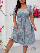 Woman modeling floral summer dress in blue and white print