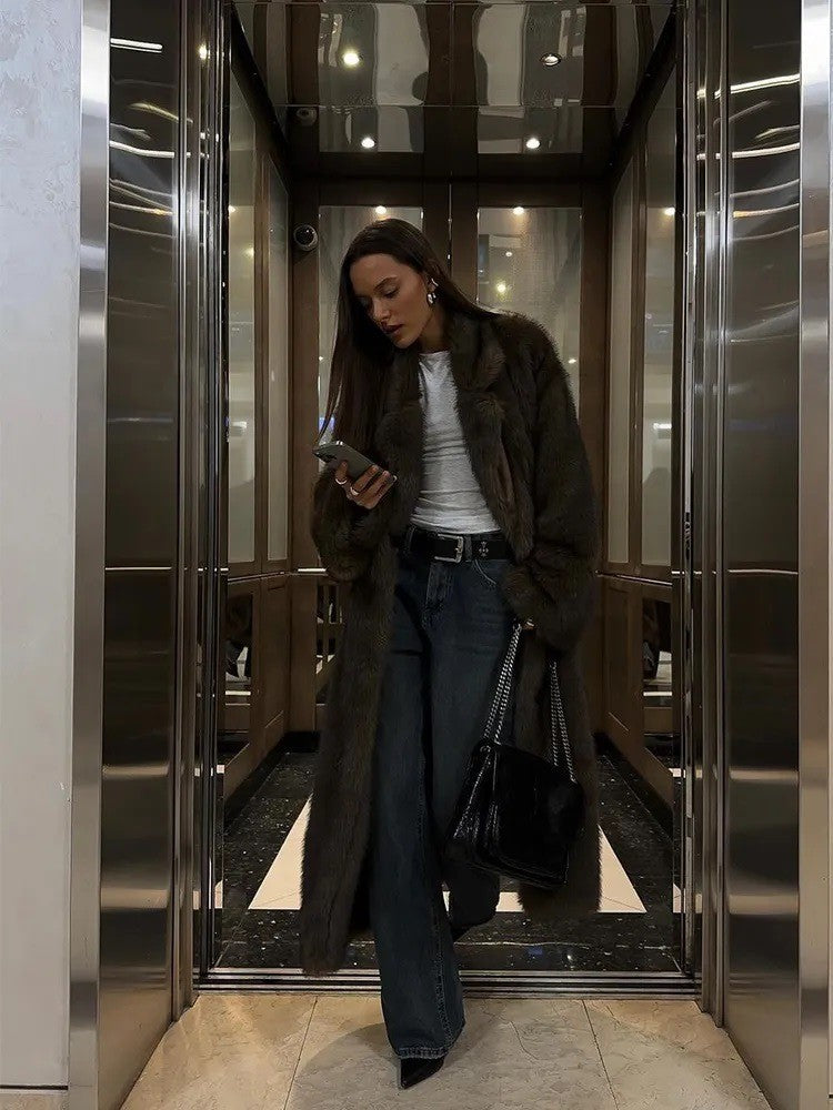 Brown vintage faux fur jacket with white shirt, blue jeans, black heels, silver bag