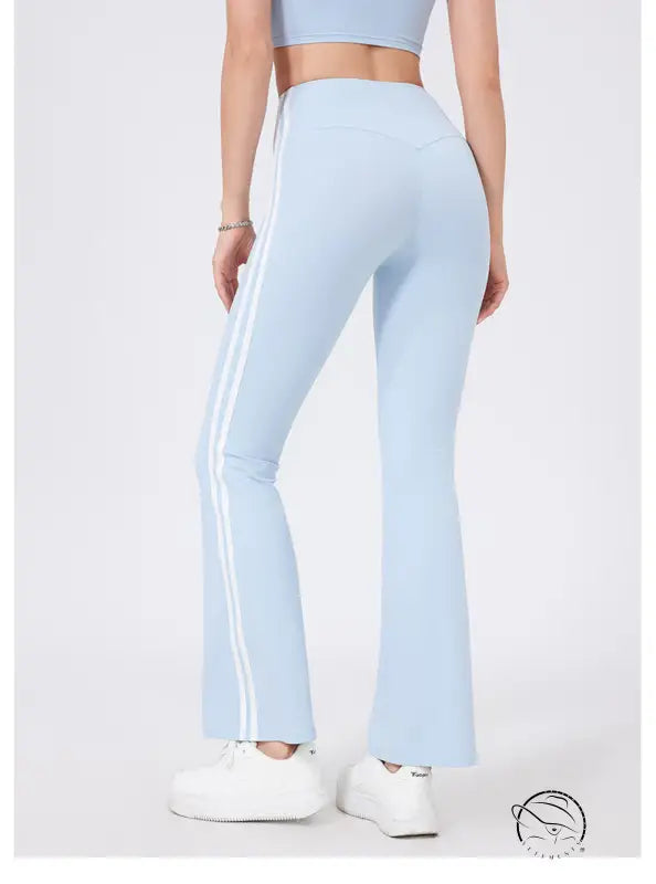 Light blue high waist yoga pants with white stripes and peach hip raise