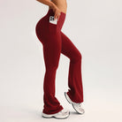 Red high-waisted flared langry yoga pants with side pocket holding smartphone