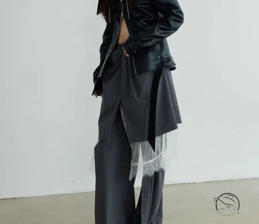 Black leather jacket over grey wide-leg pants suit with white lace detailing