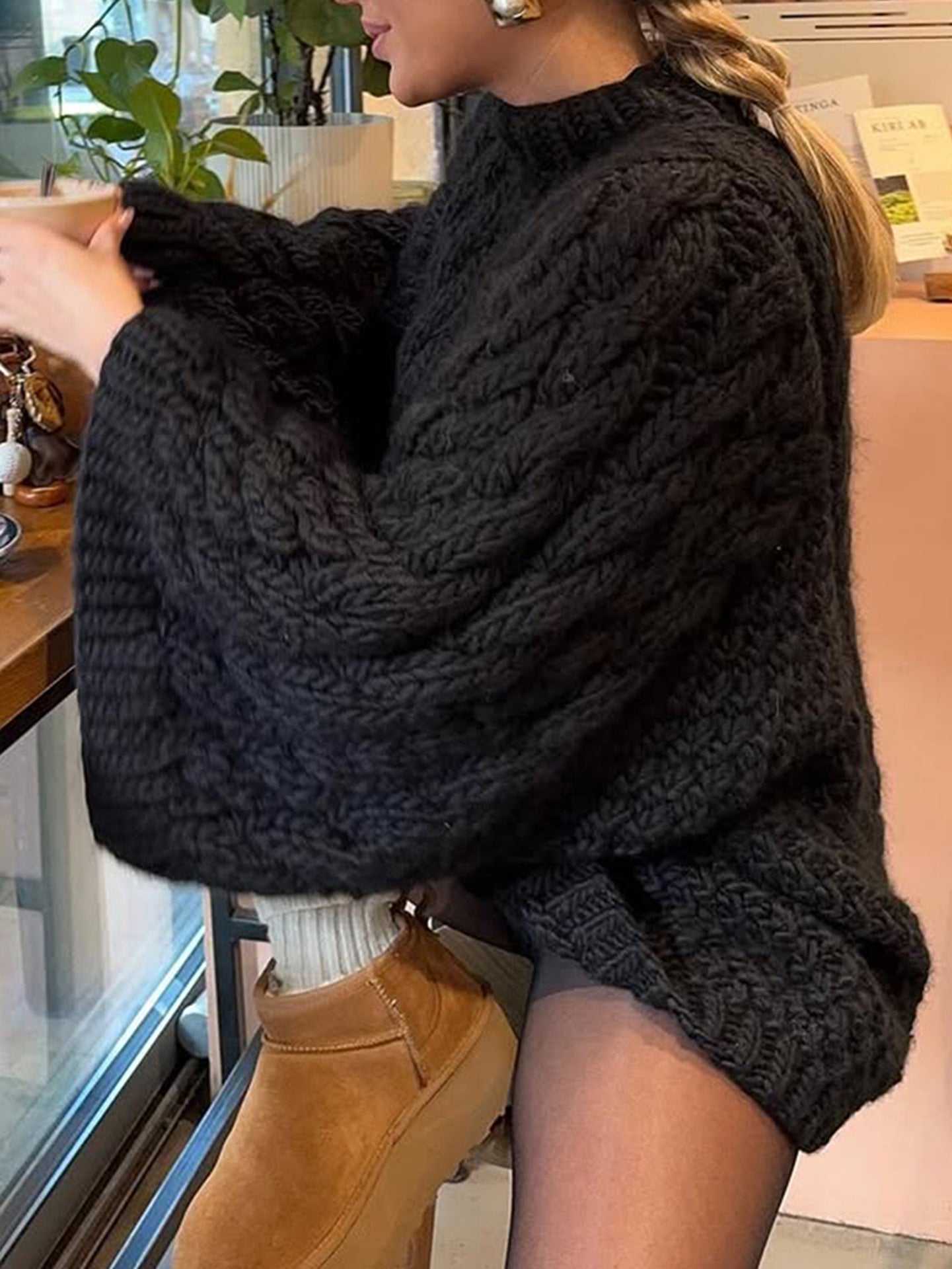 Black cable knit long sleeve oversized sweater with tan suede boots