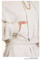 Cream-colored Winter Retro Hooded Pullover with wide sleeves and a gold chain necklace