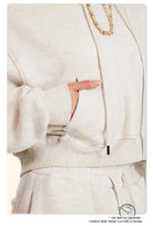 Winter retro hooded pullover: cream-colored sweatshirt with wide sleeves and gold chain necklace in langry fashion