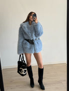 Light blue faux fur coat with black belt and Chanel bag