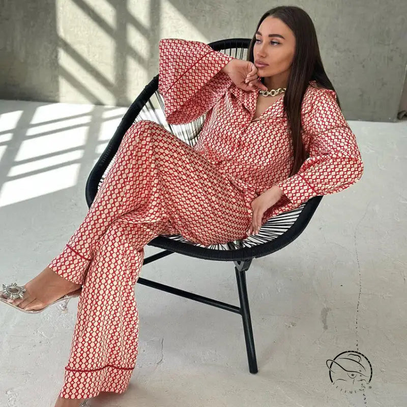 Woman in red white patterned pajama set with gold necklace and clear heels for casual comfortable homewear