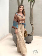 Elegant two piece set with woman in patterned blouse and wide-leg pants