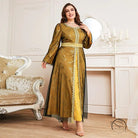 Woman in long sleeve A-line dress with golden-yellow polka dots