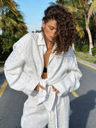 Woman in white linen outfit showcasing langry fashion from Cotton Shirt Trousers Casual Sets