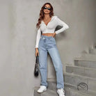Woman in elastic slimming denim trousers, white top, jeans, sneakers, black bag