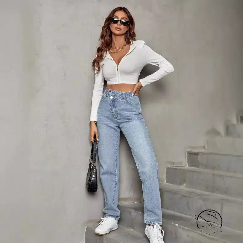 Woman in elastic slimming denim trousers, white top, jeans, sneakers, black bag