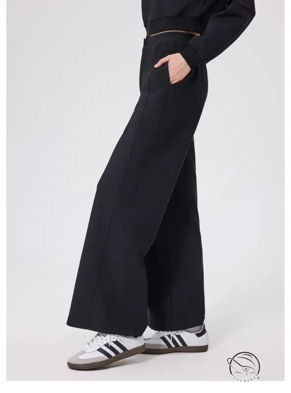 Black loose fitness warm pants with white Adidas sneakers and gold zipper