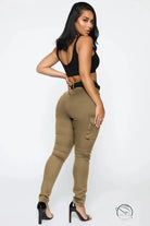 Woman in black crop top and casual skinny stretch belt sports pants