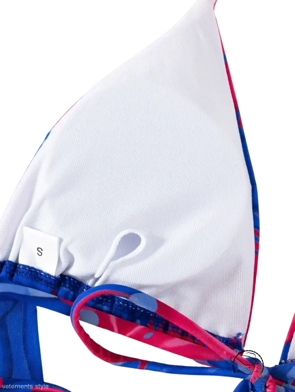 White triangle bikini top in four piece lace up swimsuit with blue and pink patterned straps, small size tag