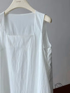 Elegant Korean style dress: white sleeveless linen garment on hanger