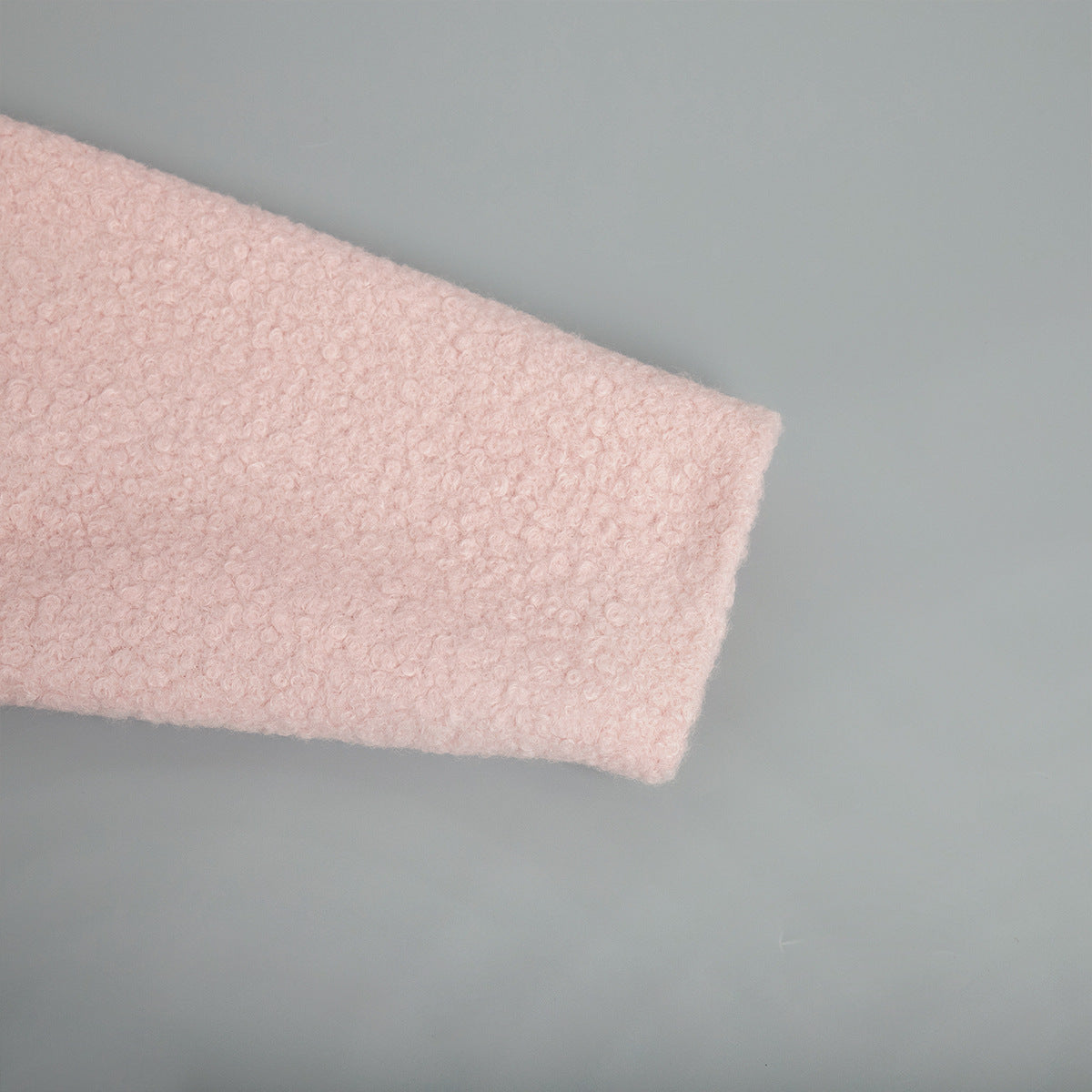 Textured pink fabric detail of Pink Short Furry Coat showcasing a pink short furry material