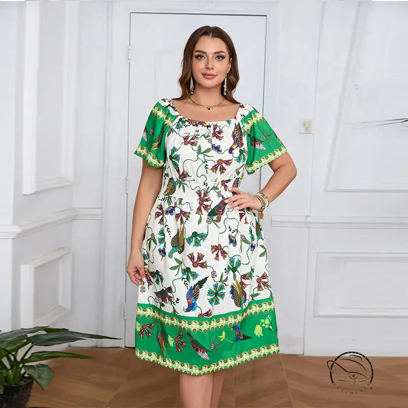 Elegant bohemian dress: white flowy knee-length with green border and floral bird patterns