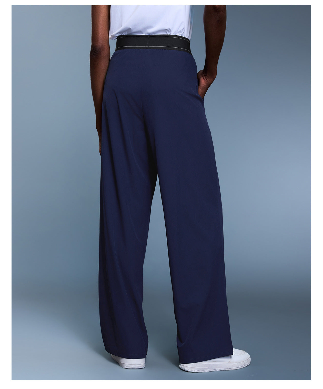 Navy blue langry fashion trousers with black waistband and white sneakers