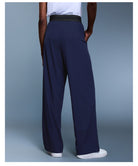 Navy blue langry fashion trousers with black waistband and white sneakers