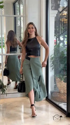 Woman in elegant sleeveless halter short top skirt set