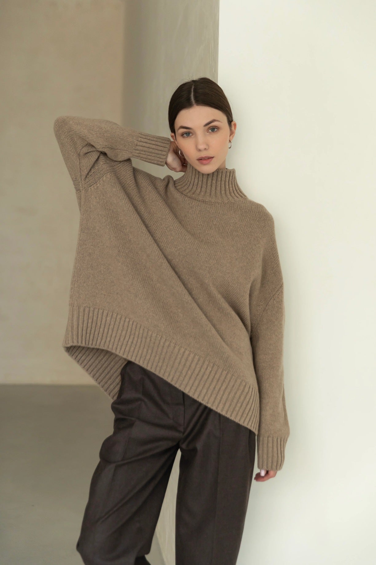 Oversized beige langry fashion turtleneck sweater with asymmetrical hem