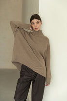 Oversized beige langry fashion turtleneck sweater with asymmetrical hem