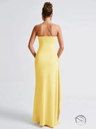 Back view of langry strapless yellow fashion gown with side slit