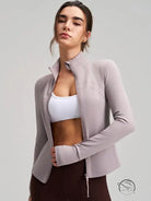 Long sleeve lavender zip-up yoga jacket with drawstring hem, pockets, and finger stalls