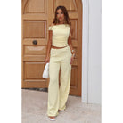 Woman in a yellow two-piece outfit showcasing the Beautiful Wide Leg Pants Two Piece Set fashion
