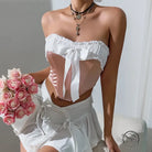 Woman in street wooden ear bow corset top with tiered skirt and rose bouquet