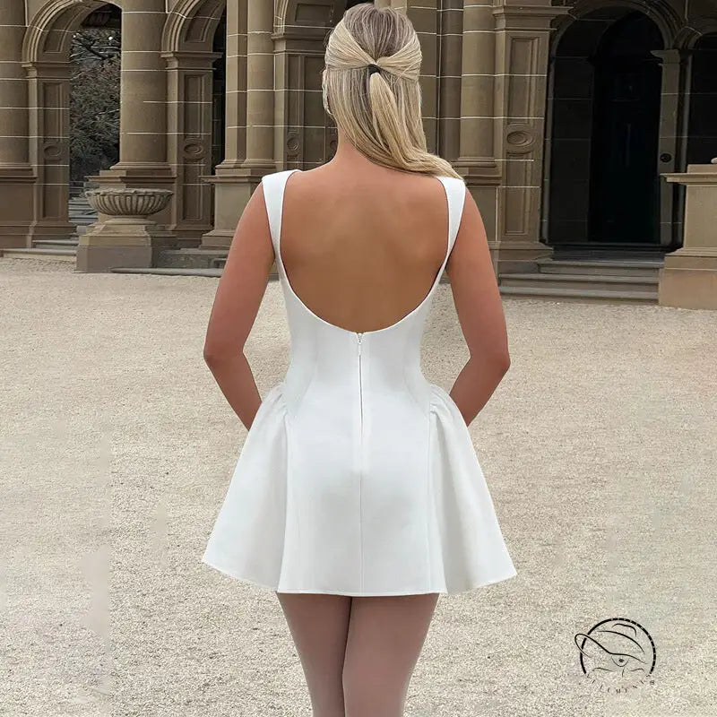 White backless langry mini dress with flared skirt and thin straps