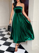 Elegant langry green velvet tube top maxi dress with pleated skirt and black heels