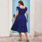 Woman in royal blue vacation casual midi dress with ruffles