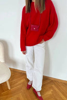 Red wool alpaca oversized sweater with pink accents and pocket detail