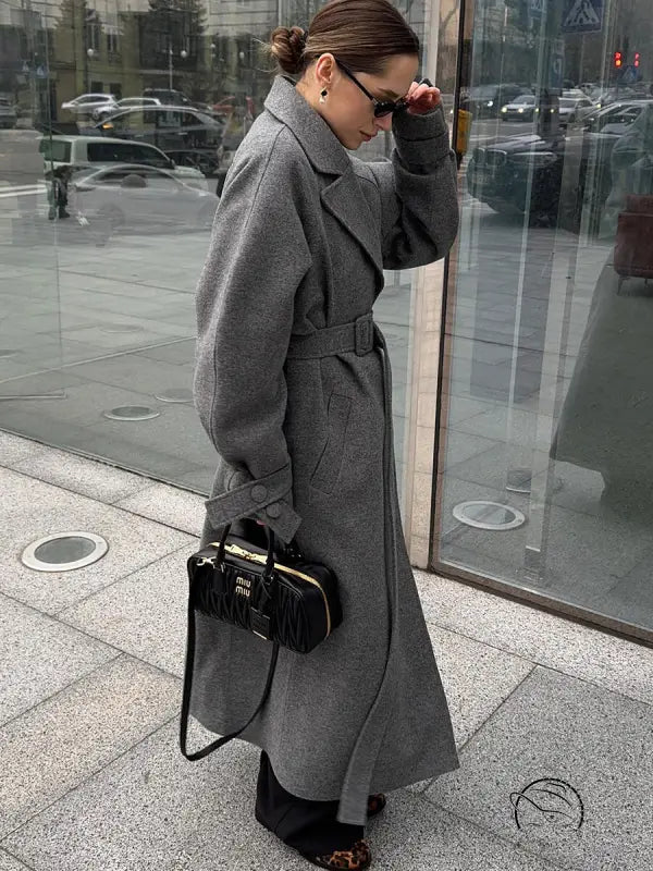 Black quilted Miu Miu handbag with gold-tone hardware in Langry fashion woolen coat