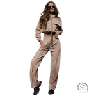Woman in elegant vetements suit with long sleeve beige tracksuit