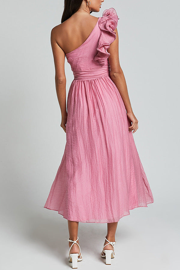 Pink one-shoulder midi dress with ruffles and flowing skirt in fashion collection