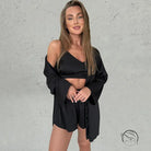 Woman in black satin home wear pajama set with camisole and shorts