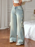 Casual wide leg jeans with lace-up cream ribbons, light-wash denim fashion