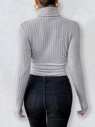 Gray ribbed long sleeve turtleneck fashion bodysuit with black jeans and gold hoop earrings
