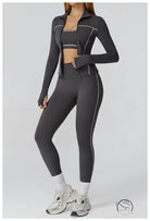 Charcoal gray lululemon leggings with white piping and zipper detail in langry fashion