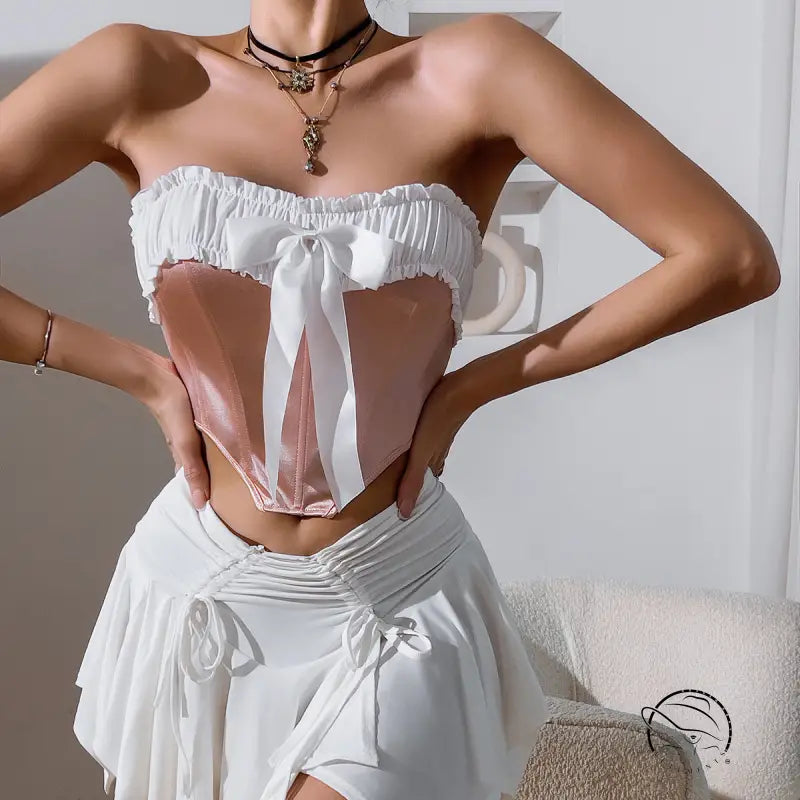 White ruffled strapless corset top with wooden ear bow and pink satin bodice