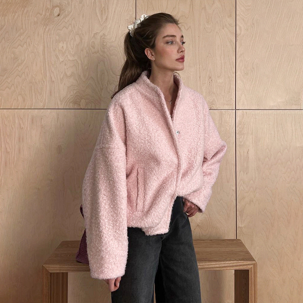 Pink short furry coat with textured design, perfect for stylish winter wear