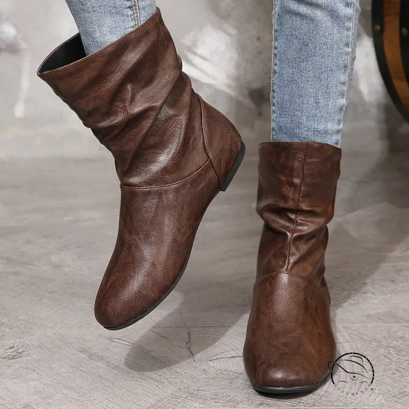 Brown low heel faux leather boots with slouchy ankle design