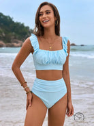 Gorgeous split bikini in light blue ruched two-piece with crop top and high-waist