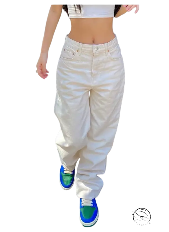 Person in slim waist loose jeans with white crop top and colorful sneakers