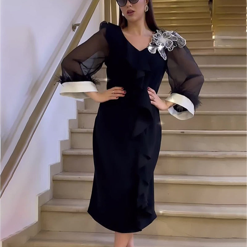 Elegant black long sleeve dress with sheer sleeves, perfect for autumn fashion