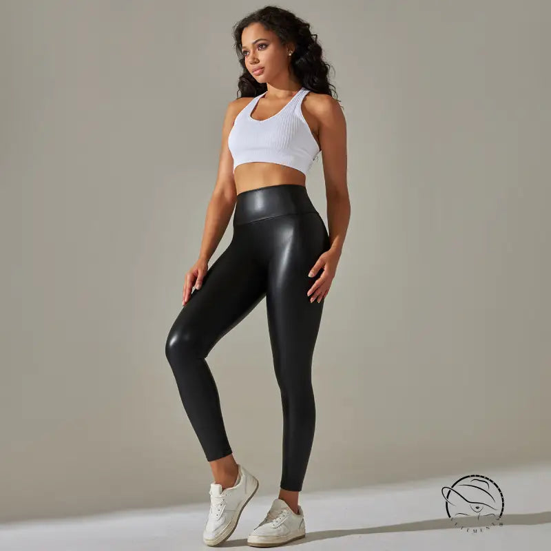 High waist faux leather leggings with white sports bra and sneakers