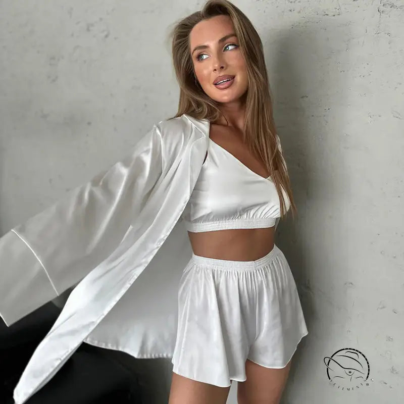 Woman in white satin three-piece home wear: crop top, shorts, robe