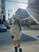 Short loose casual faux fur coat in cream with green boots and white socks
